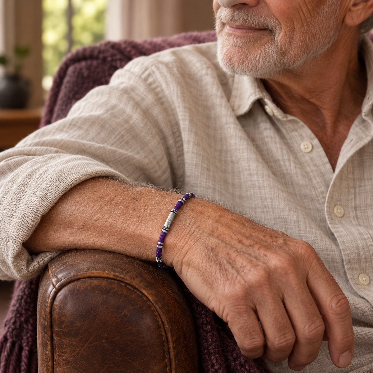 An elderly man wearing the purple awareness bracelet