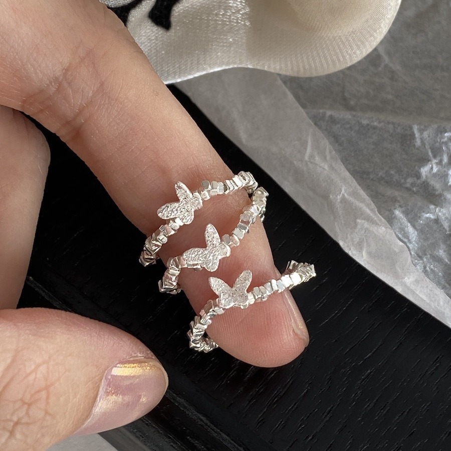An all-over 925 silver crushed silver small butterfly ring