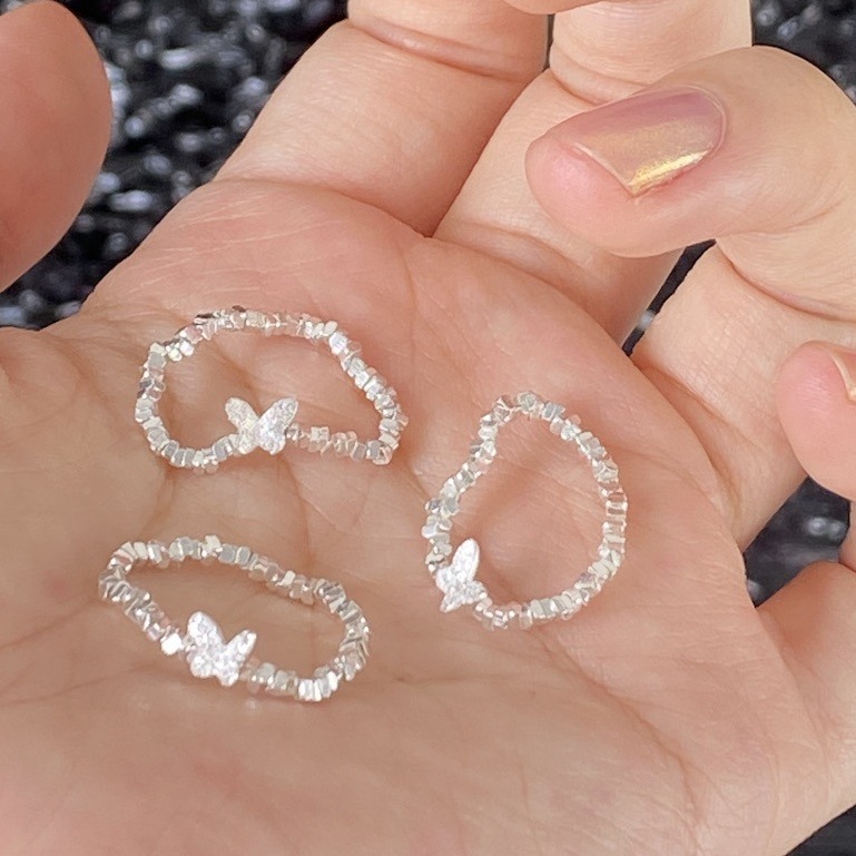 An all-over 925 silver crushed silver small butterfly ring