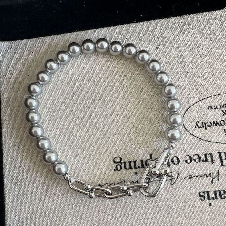 Grey faux pearl panelled horseshoe clasp bracelet