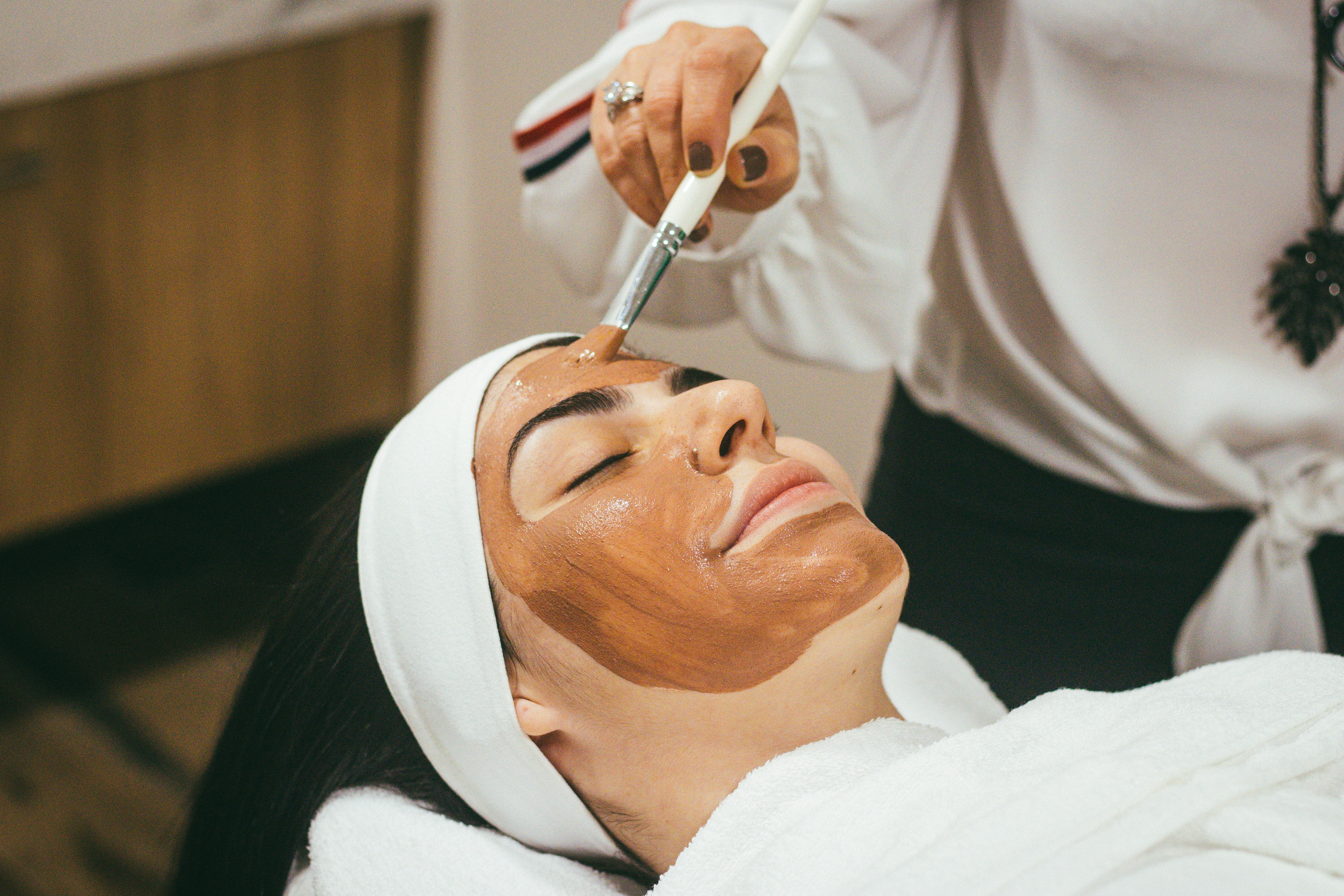 Professional beauty clinic using compact aesthetic equipment for facial treatment