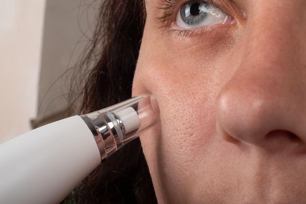 Premium Photo | Woman with vacuum face pore cleaner skin care