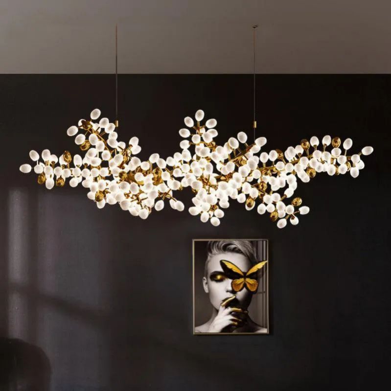 In your living room, the Zylero Grapevine Chandelier adds a charming focal point, its milk white and gold cups reflecting light with a soft, natural glow.