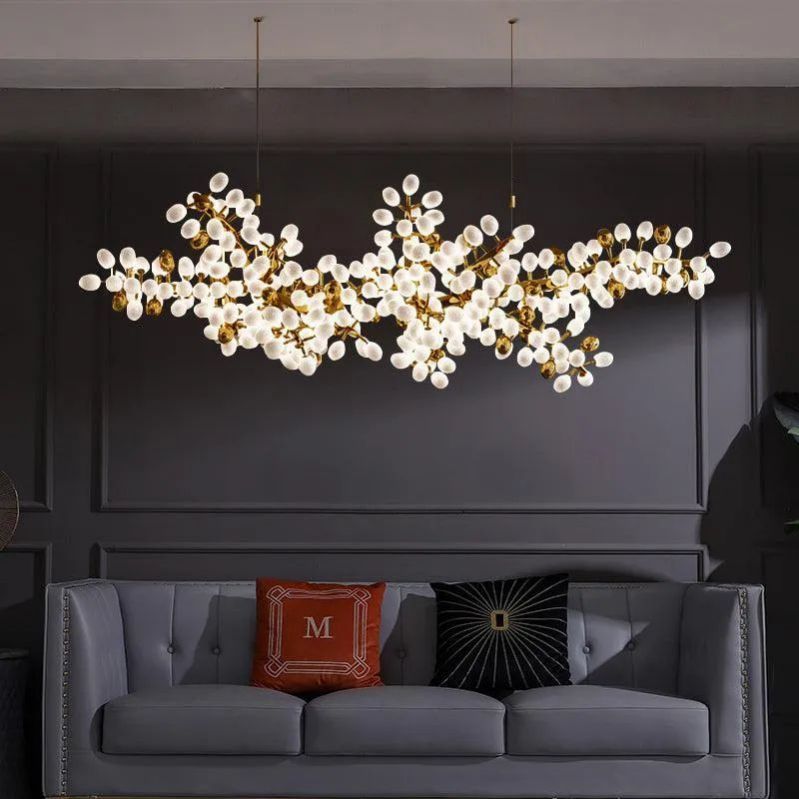 The Zylero Chandelier's vine-like branches and grape cups provide a sophisticated touch, illuminating your living room with a warm, elegant light.