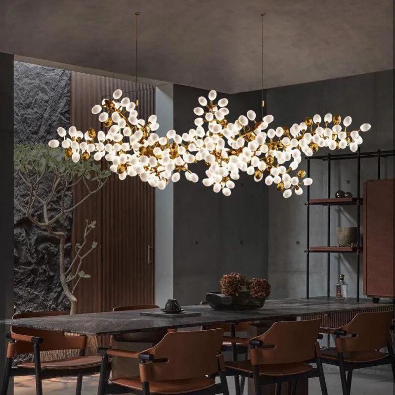 Enhance your dining experience with Zylero's chandelier, its grapevine design and gold accents creating an ambiance perfect for memorable meals.