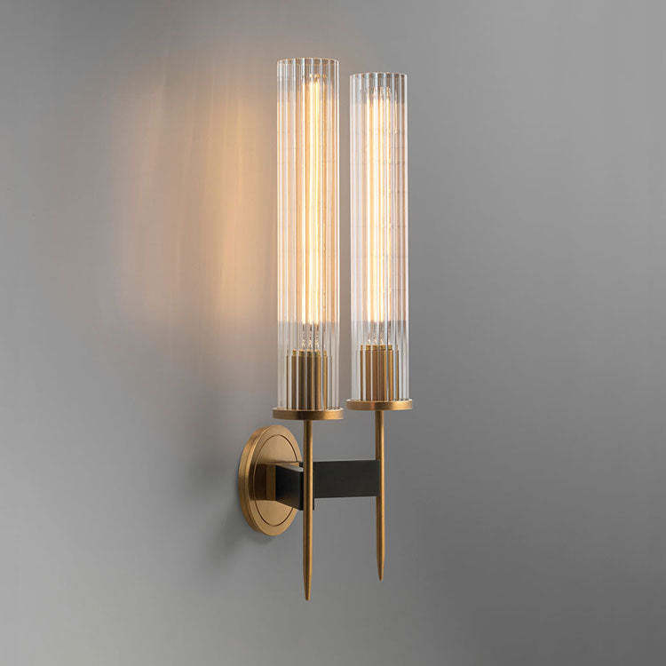 Dual glass-shaded wall sconce with a solid brass frame and hand-polished finish.