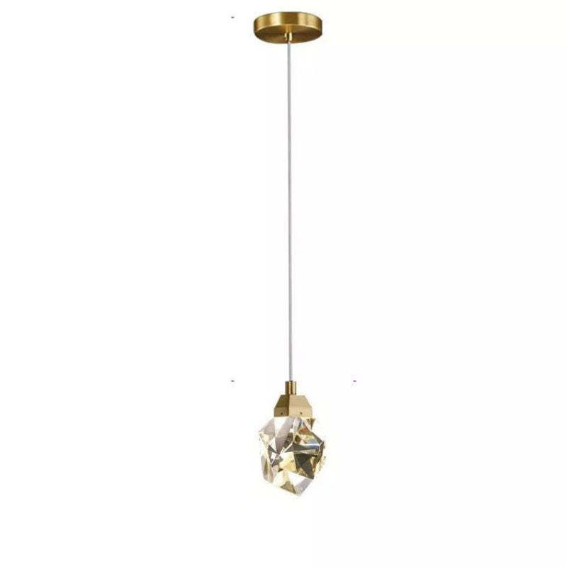Elevate your space with Zylero's artisanal pendant light, featuring patinaed crystal and handcrafted brass for a sophisticated ambiance.