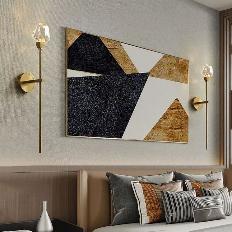 Zylero Crystal Wall Sconce: Exquisitely hand-carved crystal shade complements the polished brass, ideal for enhancing your living room's ambiance.