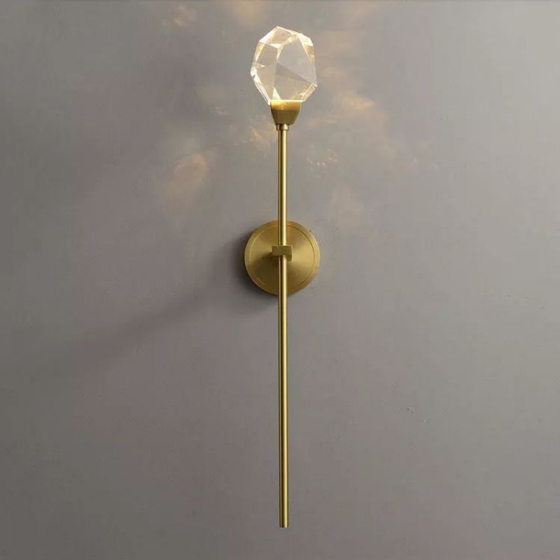 Zylero Brass Sconce: Patinaed Finish and Hand-Carved Crystal Shade.