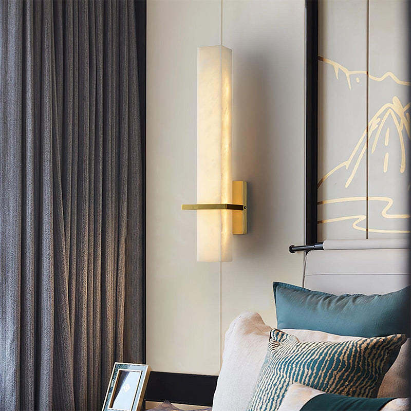 This wall sconce enhances the living room with its simple, rectilinear shape and elegant metal band.