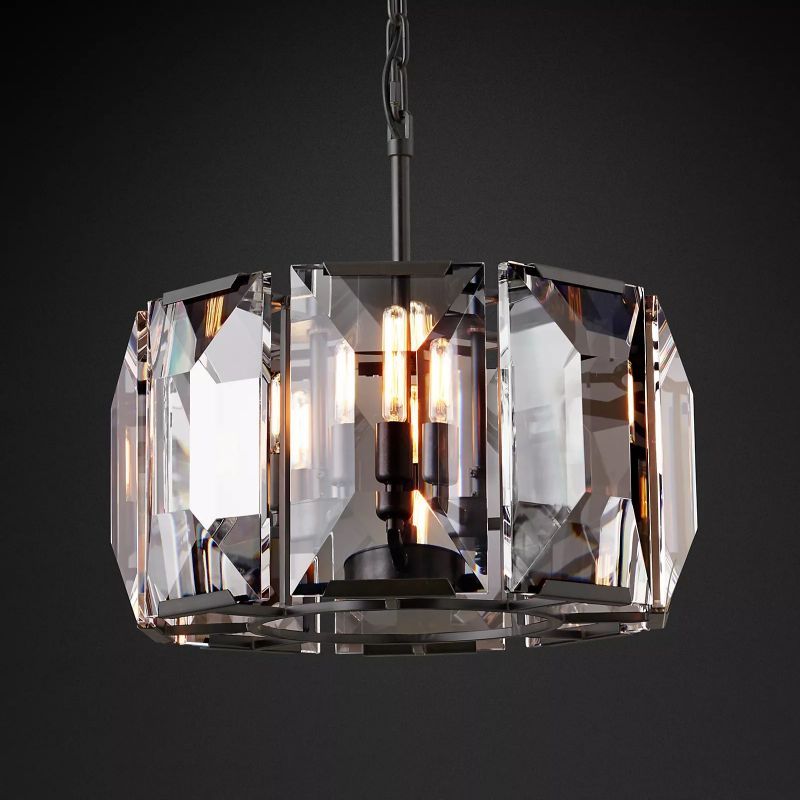 The black chandelier features a sleek, bold design, with faceted crystal prisms creating a striking contrast against its dark frame.