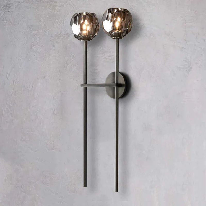 The Zylero Black Wall Sconce offers a modern contrast, its solid brass and crystal glass casting a refined light in your living space.