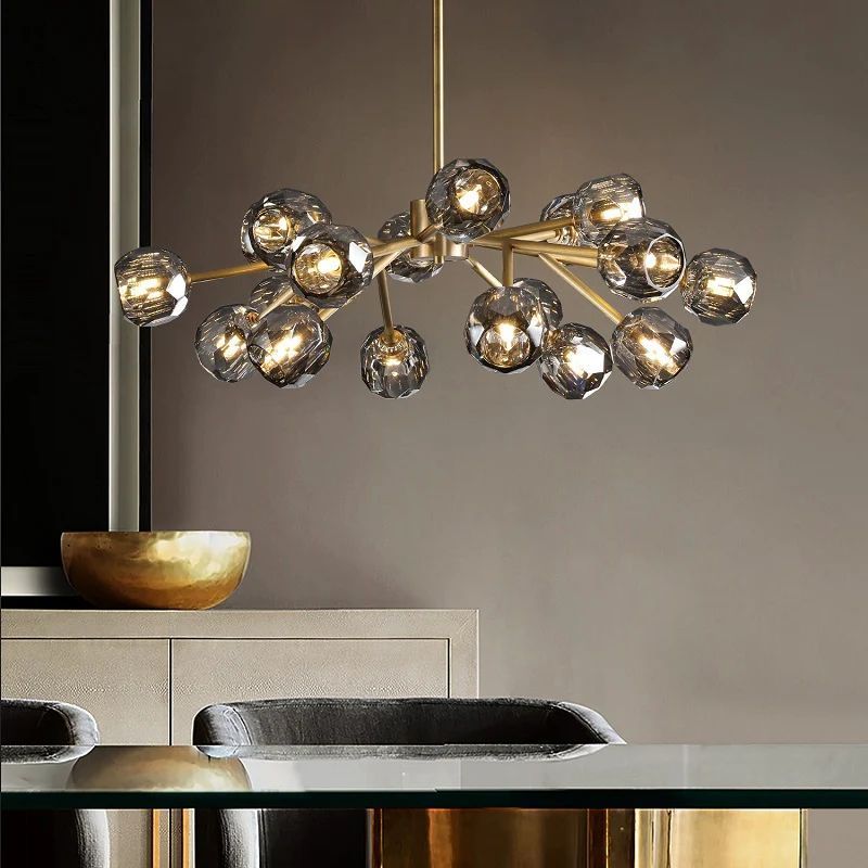 This chandelier brings a simple, industrial feel to the dining room with its robust iron design. Its large size makes it a striking focal point over the dining table.