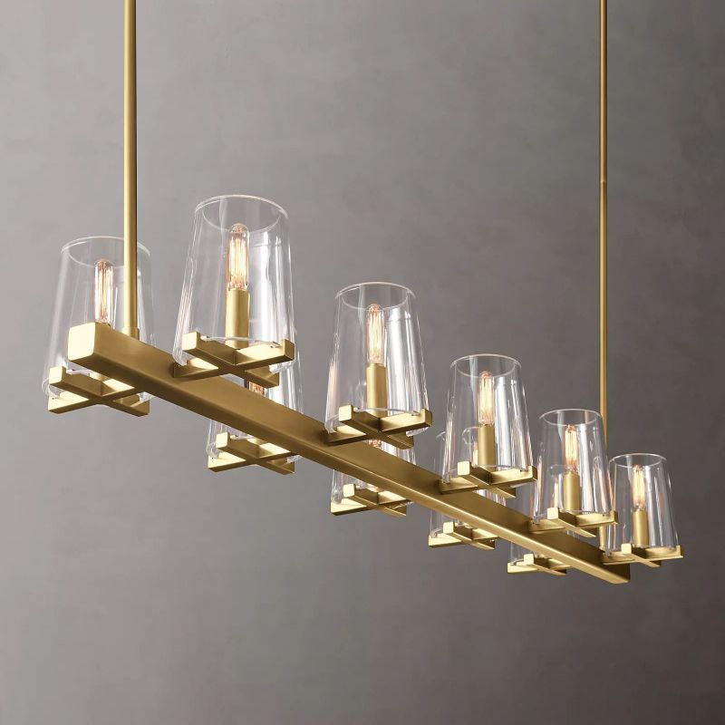 Elegant chandelier with glass shades and a sleek brass finish, creating a modern ambiance with warm, ambient lighting