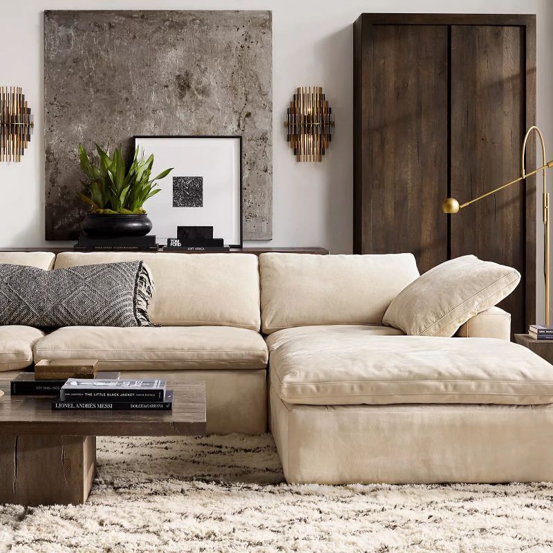 The wall sconce has modern concentric spikes. It diffuses light for a warm glow. This fixture enhances the decor.