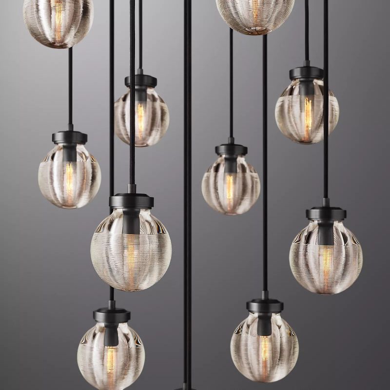 The black-finished Zylero Chandelier brings a bold, linear aesthetic to your living room, with its crystal details adding a touch of luxury.