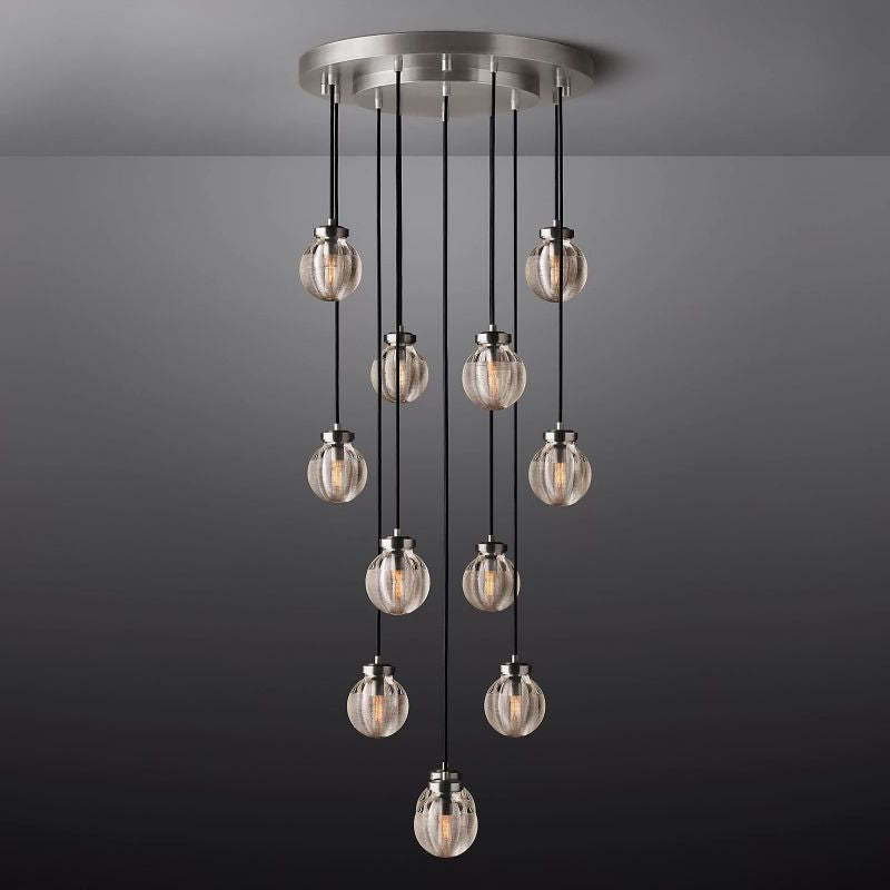 The Zylero Silver Chandelier brings a cool, contemporary glow to your living room, its silver tone and crystal glass reflecting a sophisticated, sea-inspired design.