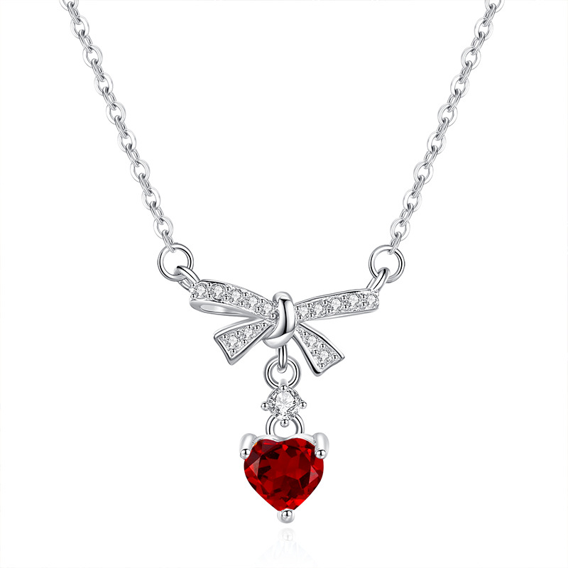 Garnet bow necklace – red gemstone under elegant silver ribbon pendant