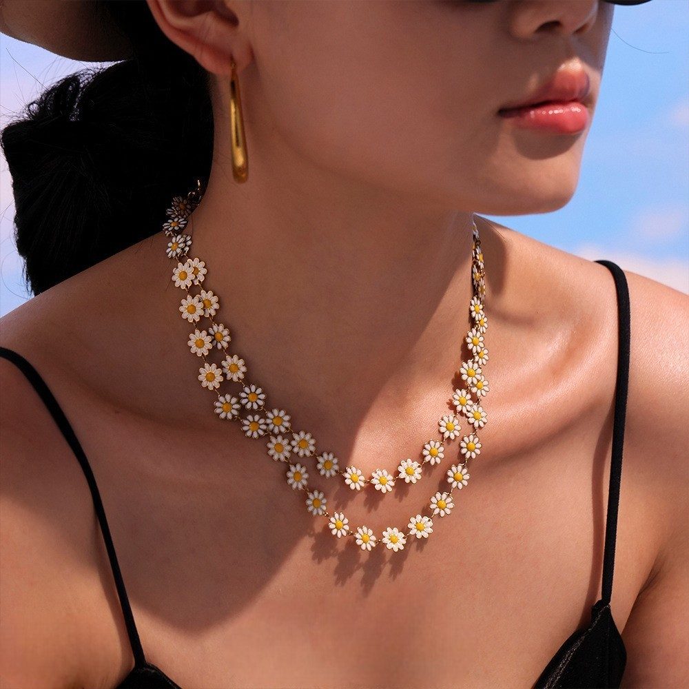 Close-up of daisy charm bracelet and anklet in modern jewelry fashion look