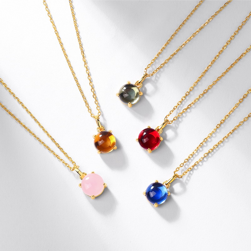 January birthstone cabochon pendant on model’s collarbone