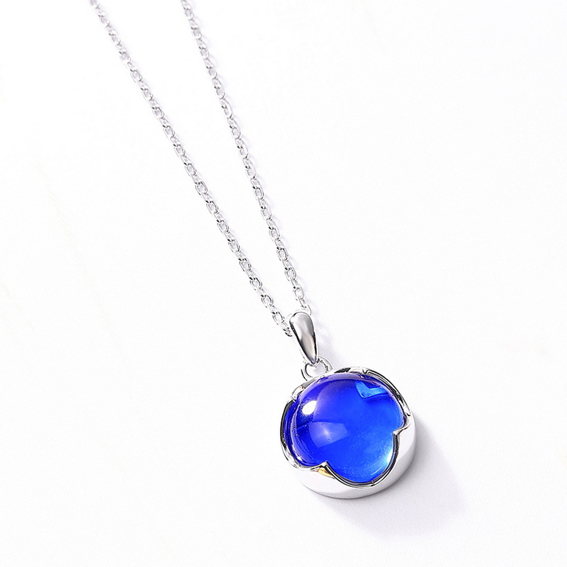 Blue crystal birthstone necklace layered on model
