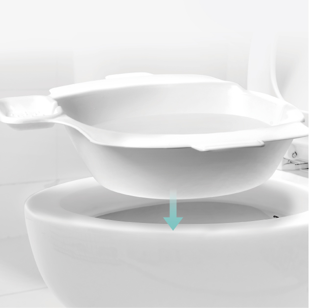 Kegel8 Portable sitz bath positioned over a standard toilet bowl, illustrating how the basin sits securely inside the toilet for perineal soaking and intimate cleansing. 