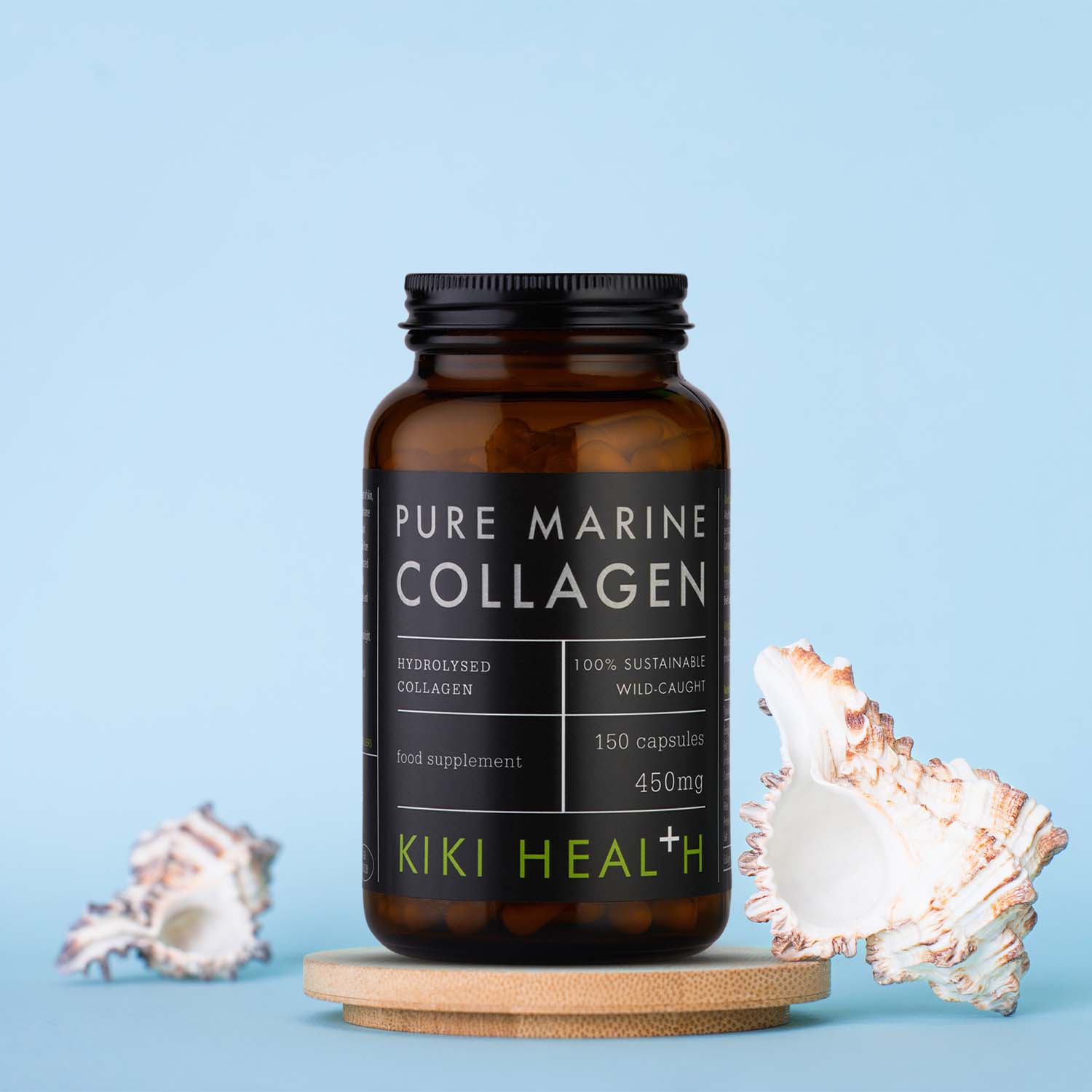 KIKI Health Pure Marine Collagen Capsules in a dark glass jar displayed on a wooden stand with decorative seashells against a light blue background.