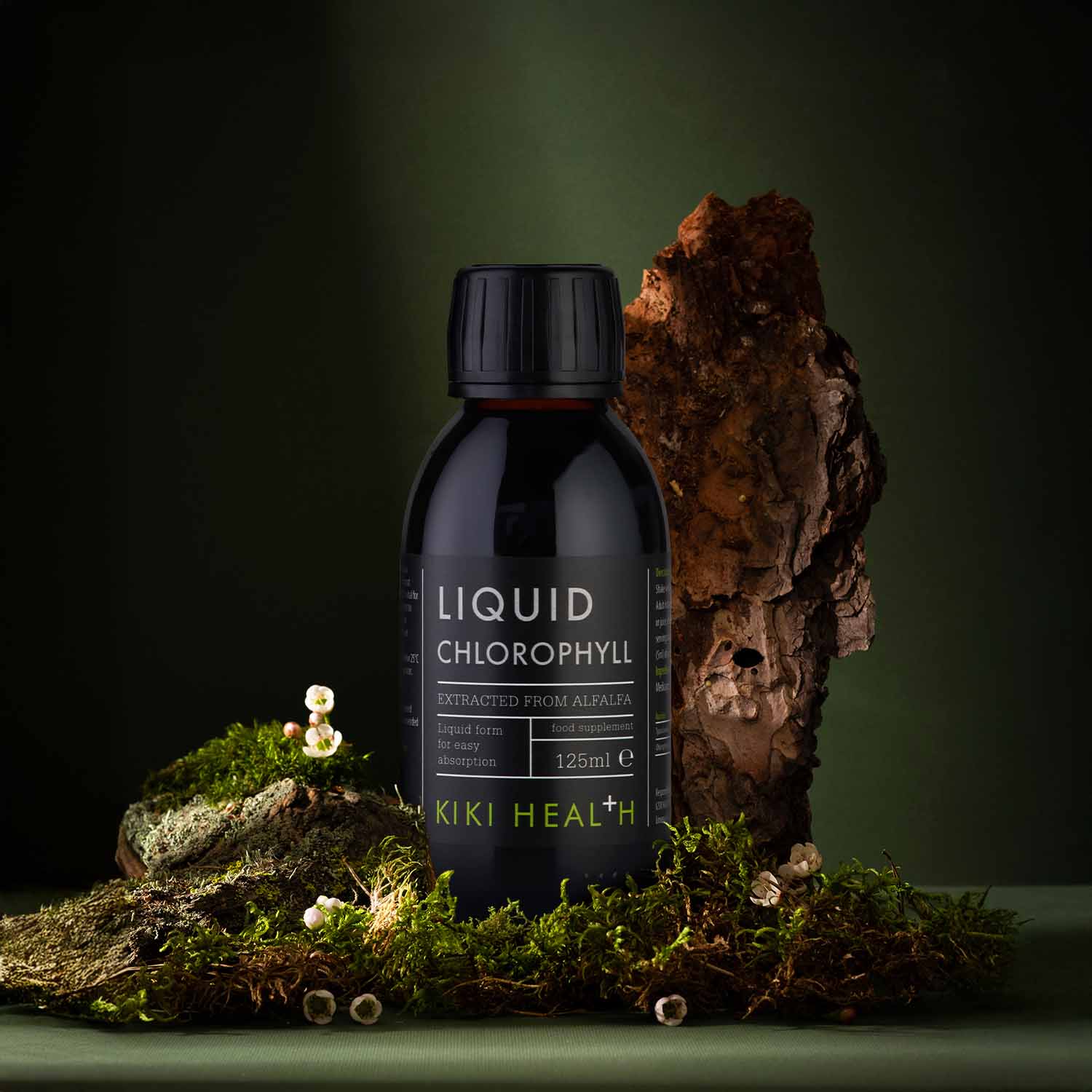 KIKI Health Liquid Chlorophyll 125ml bottle displayed on a natural moss and bark setting, highlighting plant-based chlorophyll extracted from alfalfa for detox support, digestion, energy, and skin health.