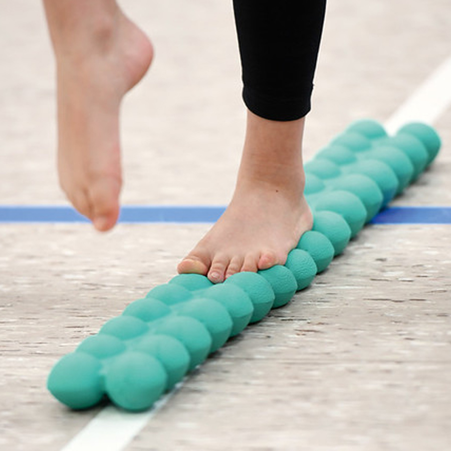 Sissel Spinefitter Junior - Child’s bare foot balancing on a Spinefitter posture and balance trainer during coordination exercise.