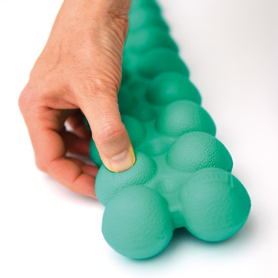 Junior Spinefitter physiotherapy tool demonstrating soft, pressure-responsive surface for posture training