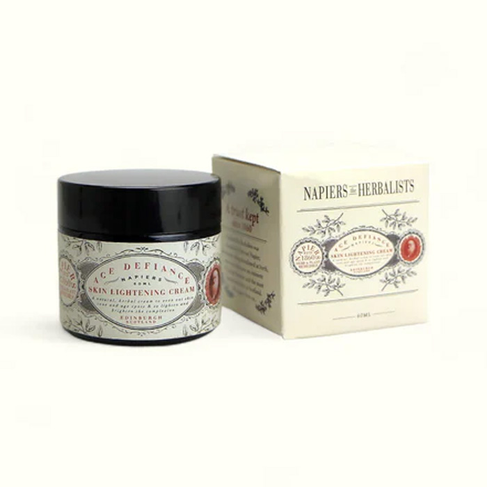 Napiers Age Defiance Skin Lightening Cream shown with jar and outer box packaging, a vegan herbal moisturiser made with chamomile, chickweed, lemon and licorice root to brighten skin tone, soothe sensitivity and support mature, radiant skin.