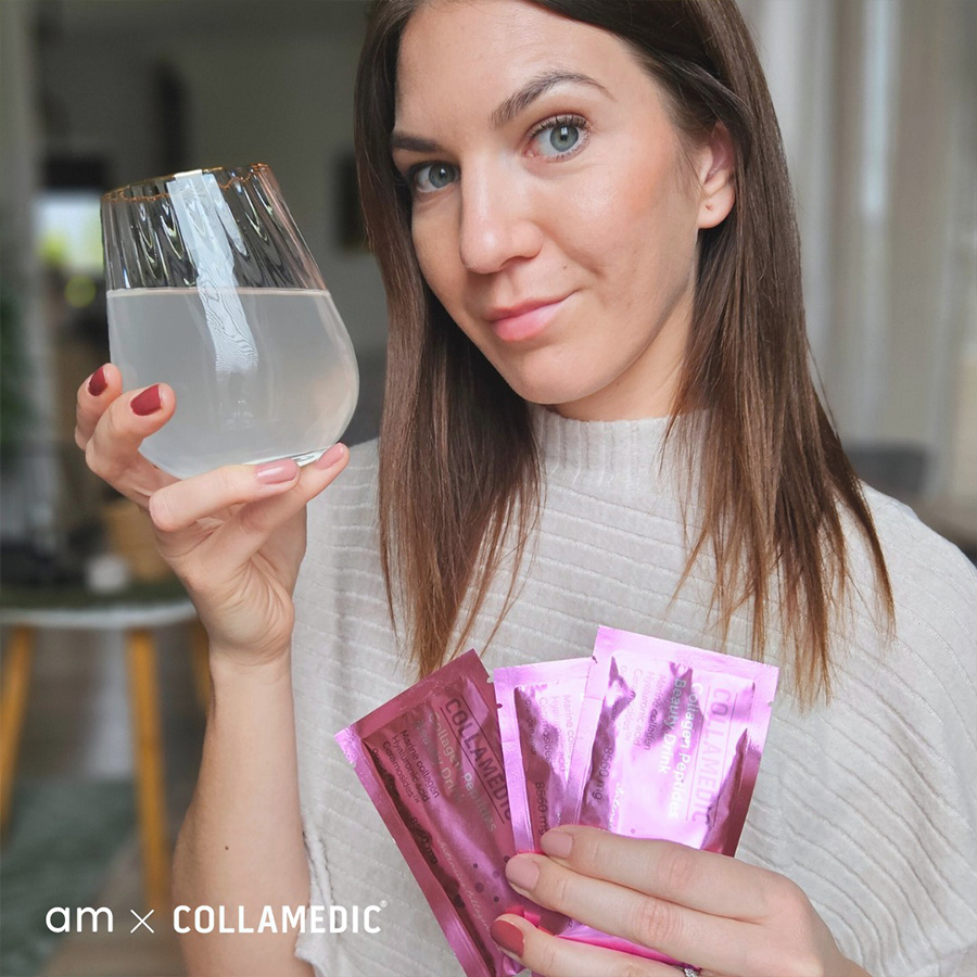 Person holding a glass of prepared COLLAMEDIC Collagen Peptides Beauty Drink and several pink sachets, demonstrating daily use of marine collagen beauty supplement designed to support skin hydration, radiance, and overall beauty from within.