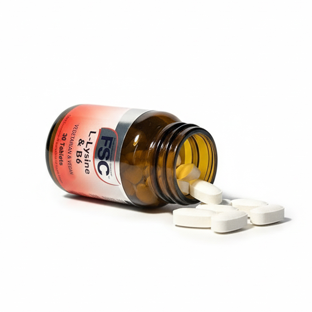 L-Lysine 500mg with Vitamin B6 supplement bottle lying on its side with tablets spilling out on a white background, vegetarian and vegan food supplement by The Food Supplement Company designed to support immune health, skin repair, and energy metabolism.