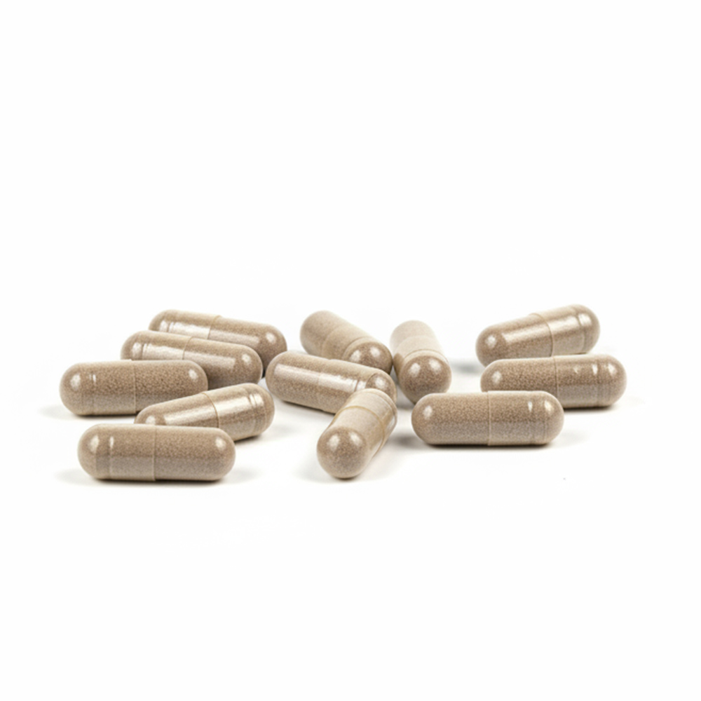 Close-up of beige vegan capsules on a white background, showing individual Shilajit 1500mg supplement capsules used for daily energy, stamina, and cognitive support as part of a natural wellness routine.