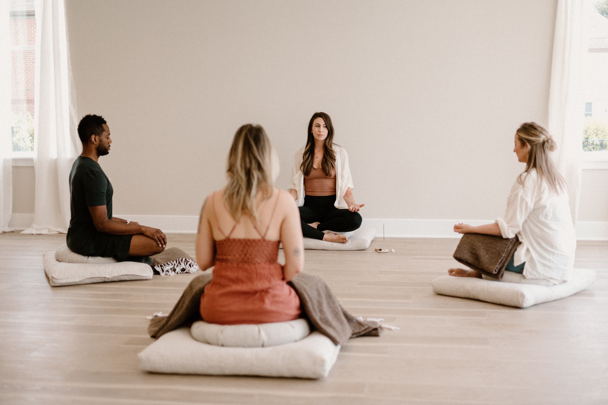 Small group meditation session with participants sitting cross-legged, used to represent relaxation practices that support anxiety and depression relief.. Mindfulness - Techniques To Help Relieve Anxiety and Depression-StressNoMore