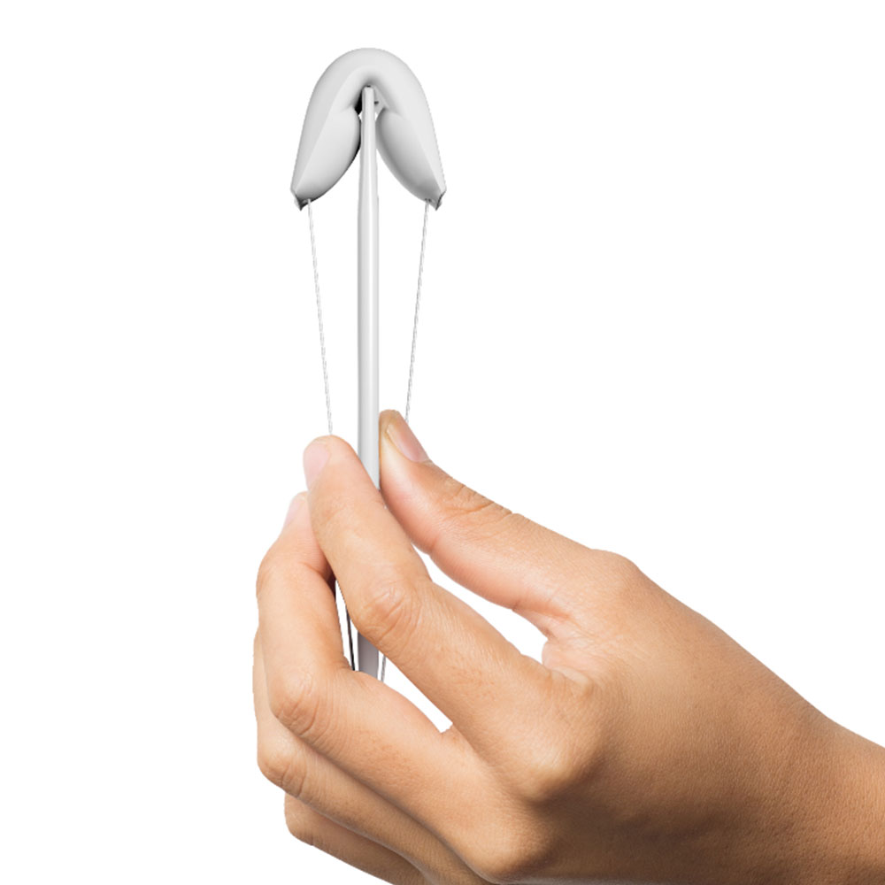 Hand holding a Contrelle bladder support pessary, a U-shaped device used to lift and support the bladder to reduce stress incontinence, leaks and pelvic floor weakness. Stressnomore.
