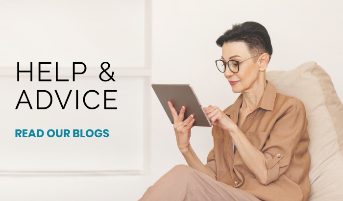 Older woman with short dark hair and glasses using a tablet while sitting on a sofa, beside text saying Help & Advice and Read Our Blogs.