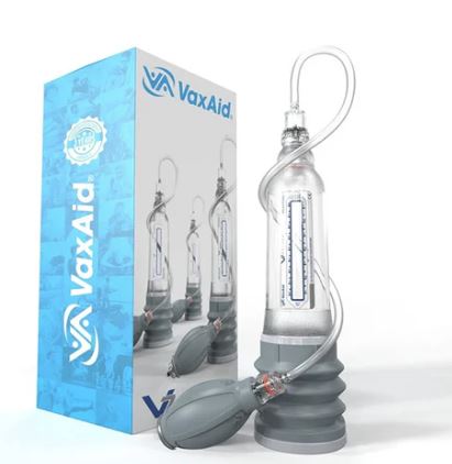 VaxAid v7 Deluxe vacuum erection device shown with retail box, clear polycarbonate cylinder with pressure gauge, handball pump and tubing, designed for safe, drug-free erectile dysfunction treatment using air or water therapy.