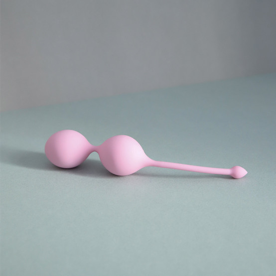 Femintimate Pink silicone Kegel balls with a double-ball design and retrieval stem, shown on a neutral background, designed for pelvic floor strengthening, postpartum recovery, and bladder control support.
