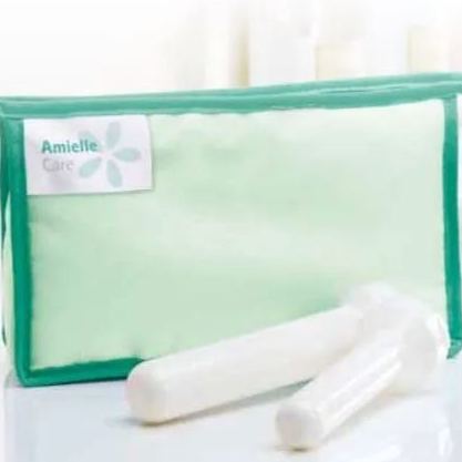 Green fabric storage pouch with white medical Amielle Care Vaginal Dilator Set  placed in front, showing smooth rounded ends and compact design, suitable for pelvic floor therapy, vaginal dilation, or clinical rehabilitation use.
