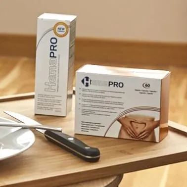 HemaPro haemorrhoids treatment products displayed on a wooden tray, including HemaPro cream box and HemaPro capsules box alongside a spatula.