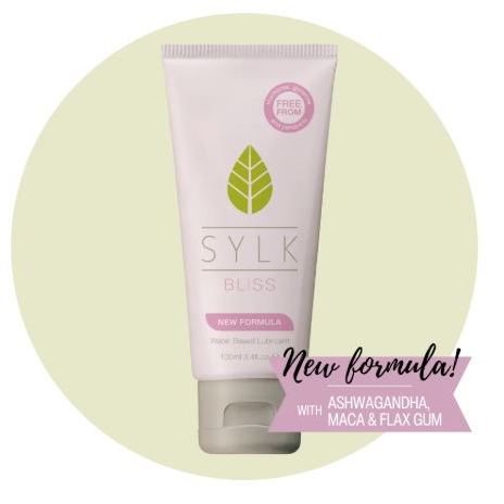 SYLK BLISS natural water-based lubricant tube with new formula badge, highlighting plant-based intimate lubricant infused with ashwagandha, maca and flax gum, designed to support gentle hydration, comfort, and a natural feel.