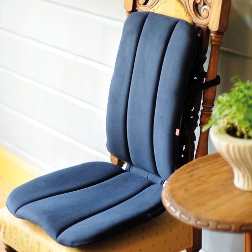Sissel DorsaBack ergonomic chair back support with cushioned padding attached to a wooden dining chair, providing posture correction and lower back pain relief while sitting.