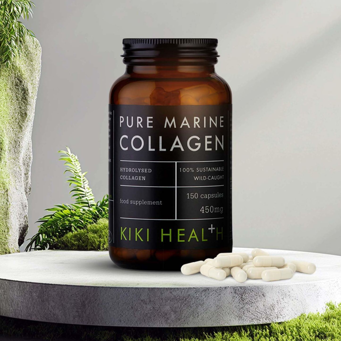 KIKI Health Pure Marine Collagen Capsules in a dark glass jar displayed on a stone surface with loose capsules and green foliage in the background.