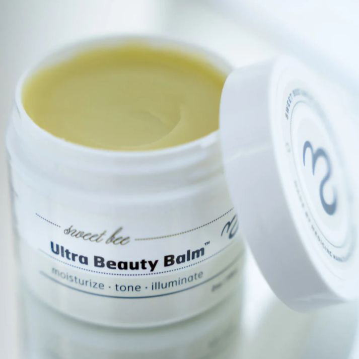 Open jar of Sweet Bee Naturals Ultra Beauty Balm showing rich organic balm texture, formulated to moisturise, tone, and illuminate skin, helping nourish dry or sensitive face and neck skin with natural ingredients.