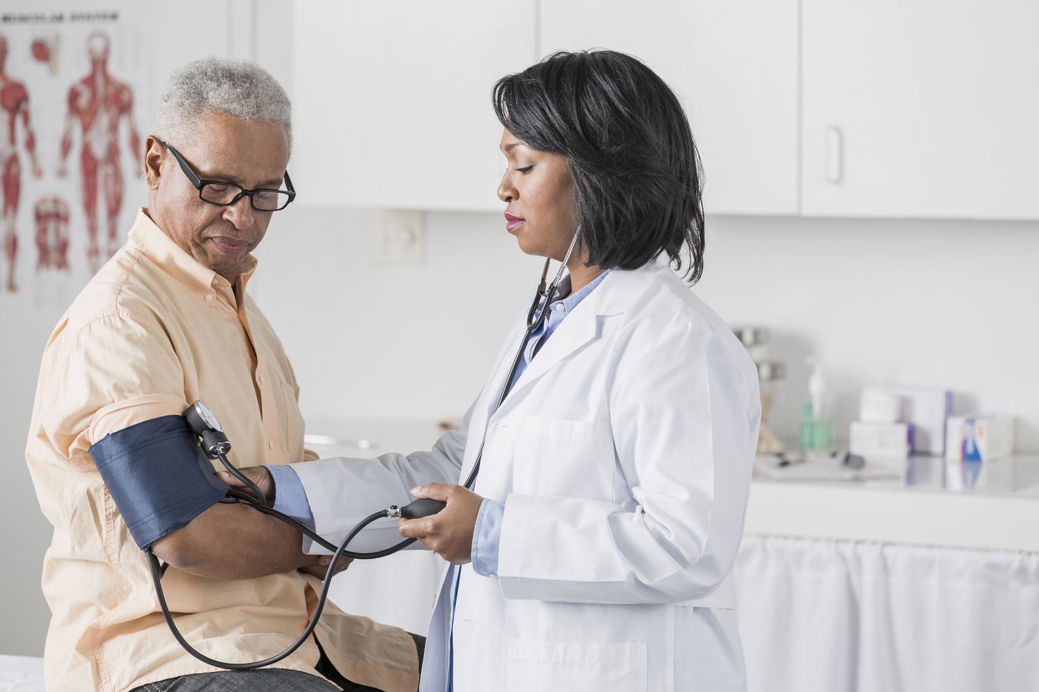 Healthcare professional measuring a patient’s blood pressure with a cuff and stethoscope in a medical examination room. 6 Ways to Avoid Dangerous Low Blood Pressure Symptoms-StressNoMore