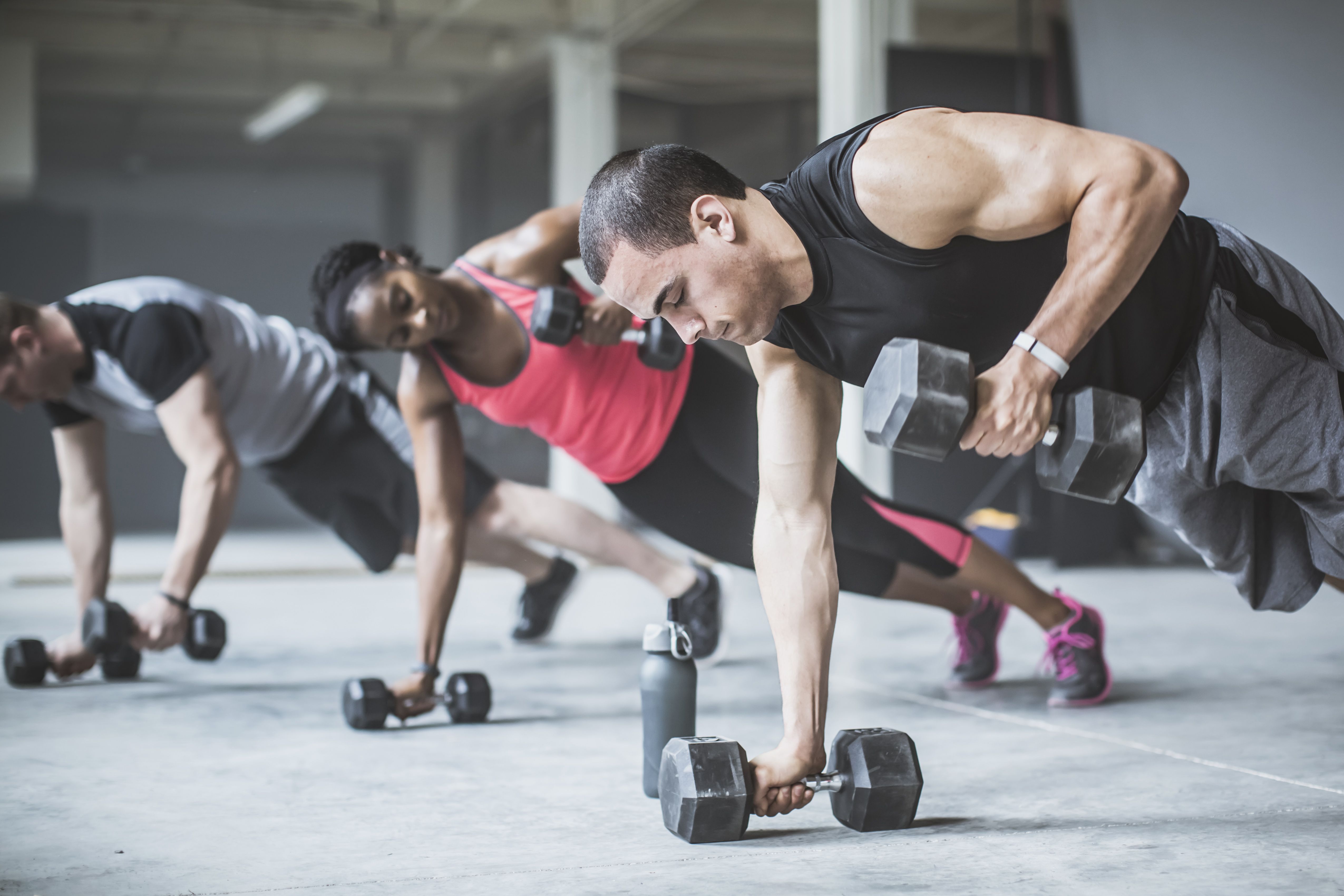 Man and woman exercising with weights.