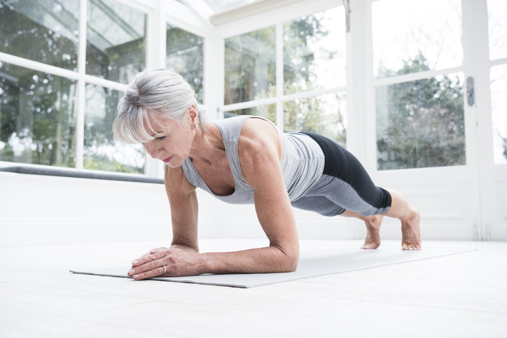 Older women holding a plank.