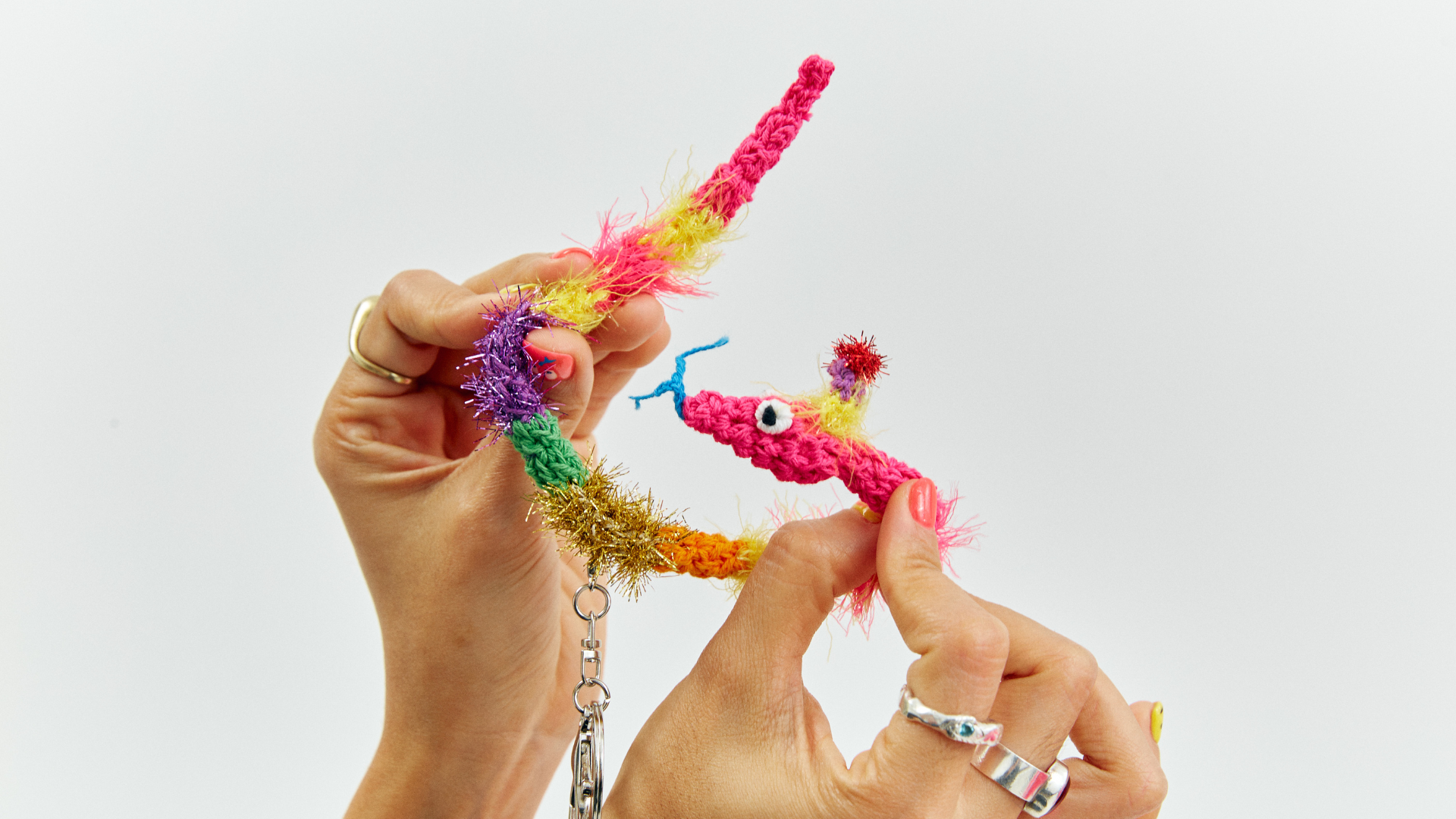FeekyStore handmade multi-color fuzzy worm-on-a-string keychain, a fun and whimsical dopamine aesthetic accessory for your bag or keys.