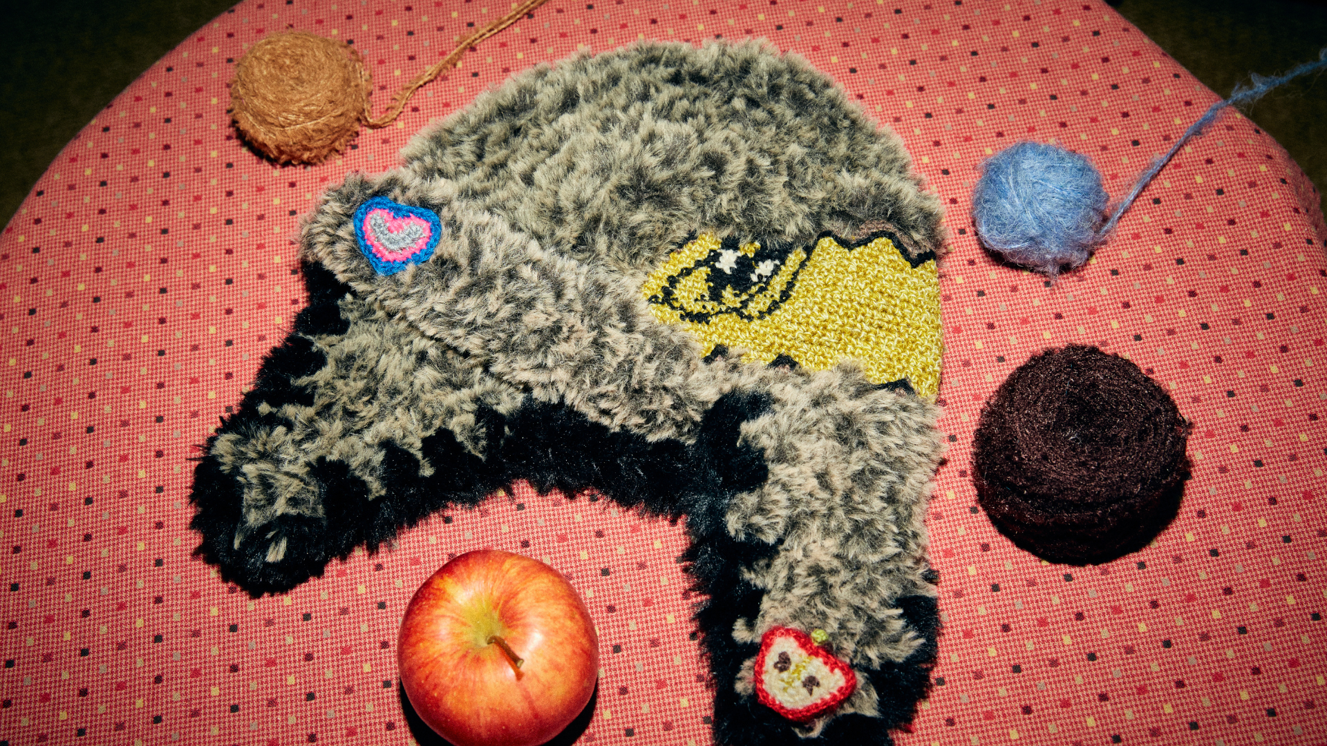 Detailed shot of FeekyStore's signature fuzzy aviator beanie with cute heart and apple appliques, perfect for achieving a soft girl and vintage street style.